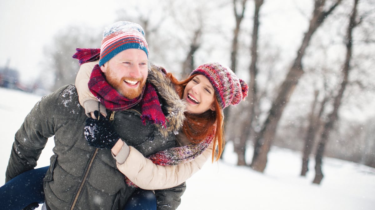 Family playing together outdoors in the snow