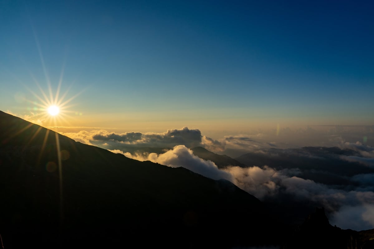 Breathtaking sunrise over mountain peaks above a sea of clouds